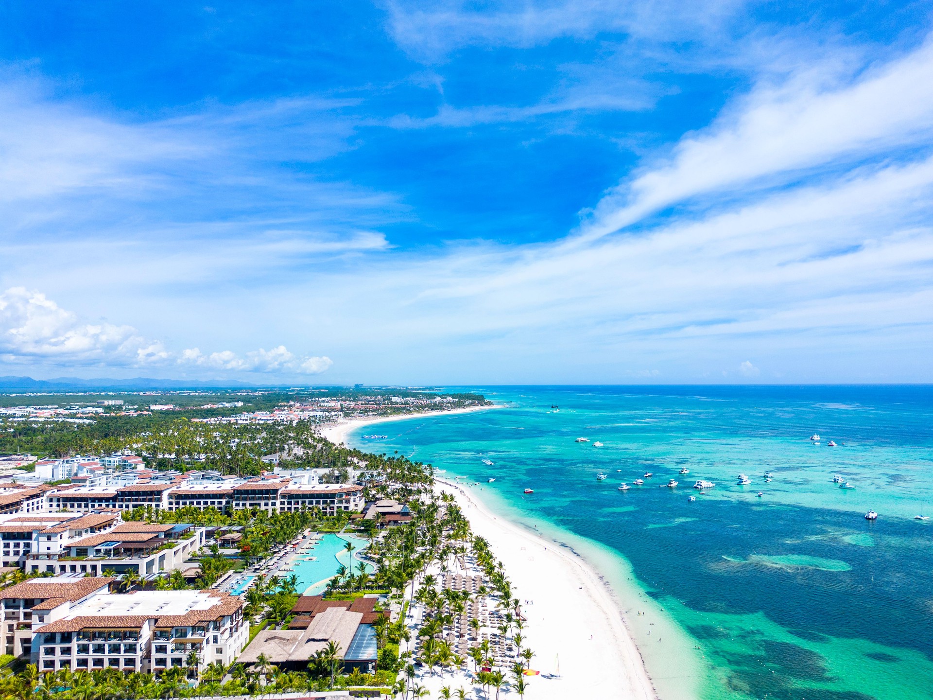 Aerial view of the Punta Cana beach with white sand and turquoise water of the Caribbean Sea. Top places for summer vacations in all Inclusive resorts and hotels in Dominican Republic